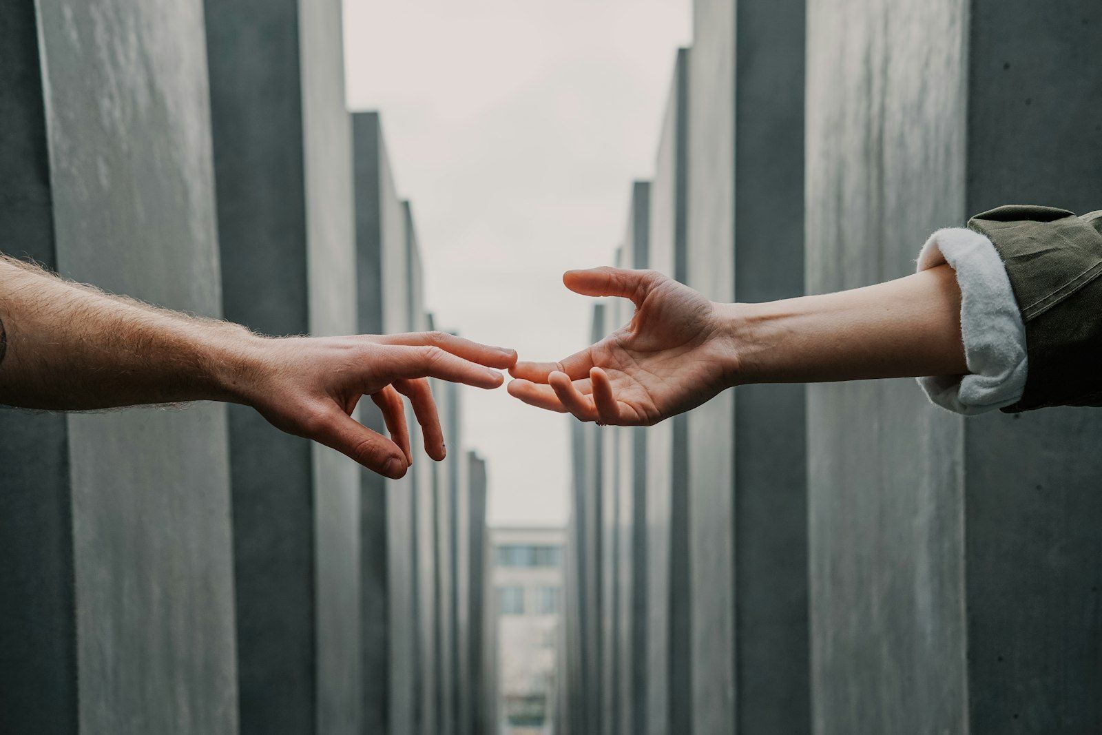 A younger hand gently holding an older person's hands