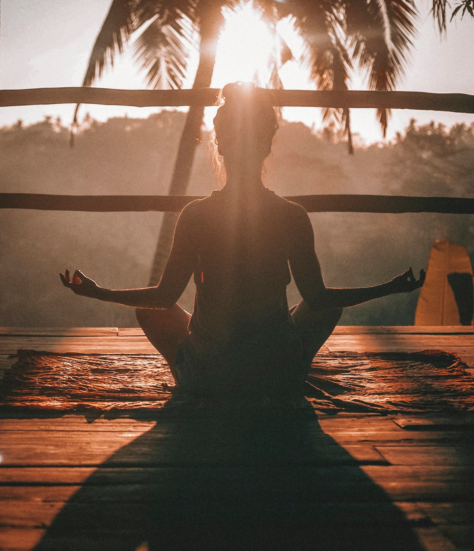 A person greeting the sunrise with open arms
