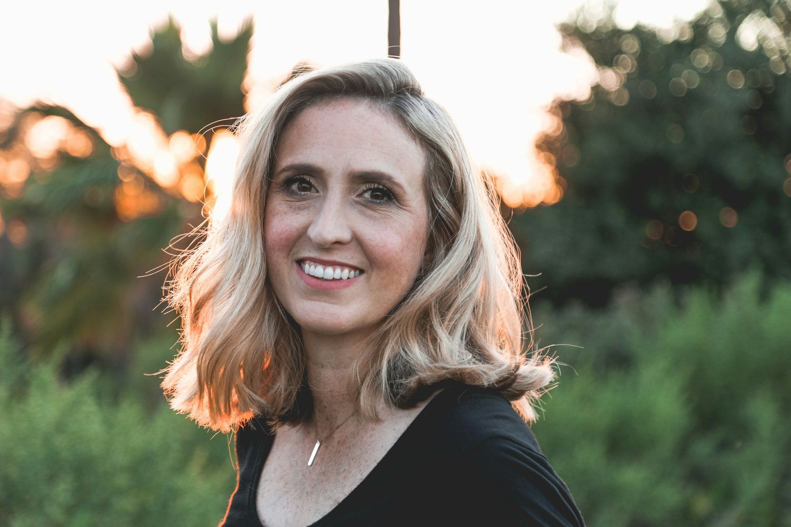 A woman smiling in warm morning light
